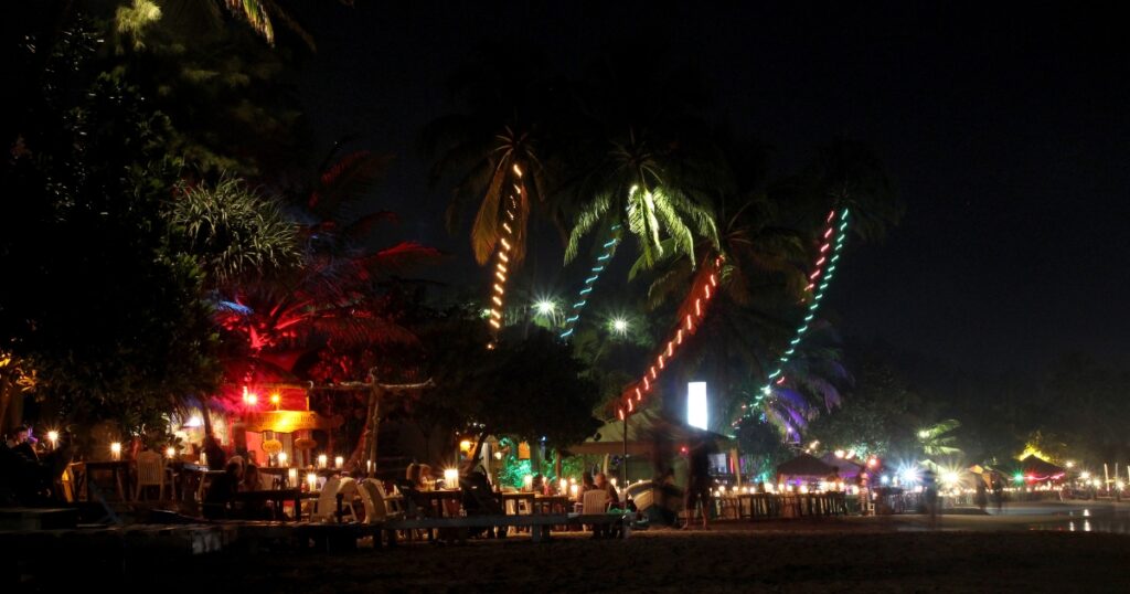 Mirrissa beach at night where restaurants directly on the sand.