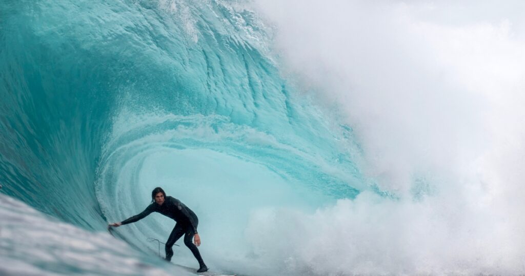 Surfer going through waves