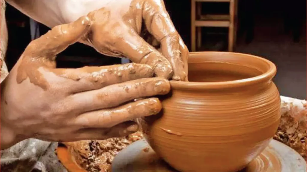 Craftsman shaping clay with his hands