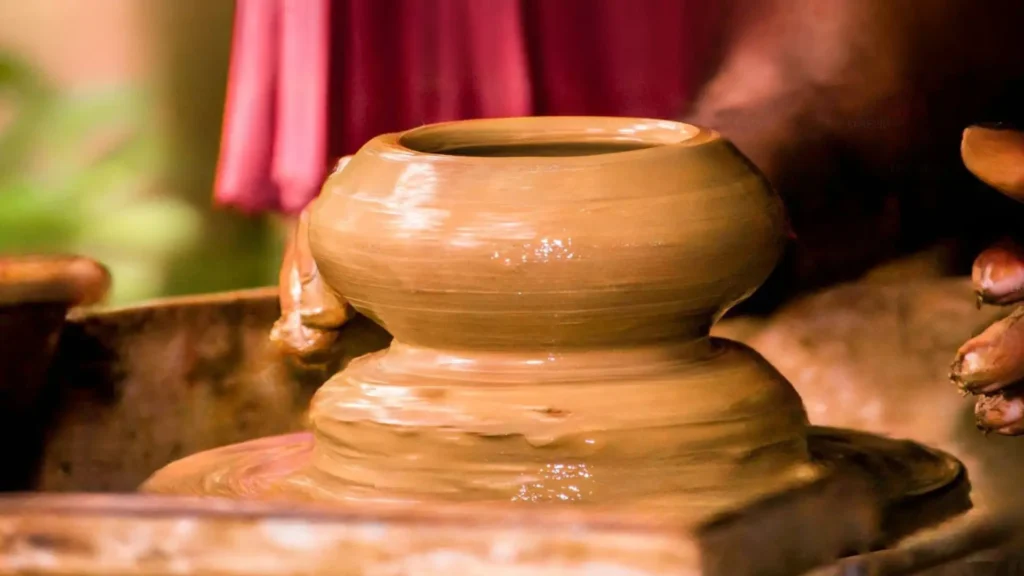 Potter shaping clay on the 2wheel