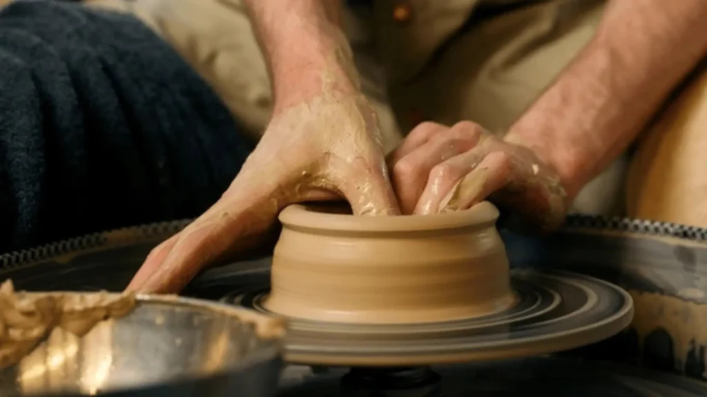 Potter shaping clay on the wheel