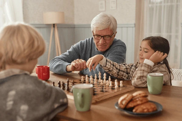 Elders and children playing draughts together