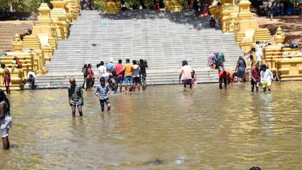 Devotees crossing the Menik Ganga